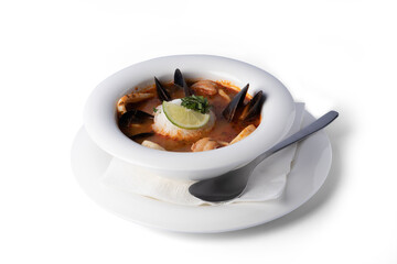 Soup with seafood on a white plate, for delivery, Mediterranean food