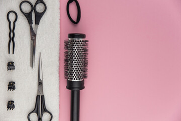 Professional hair dresser tools with copy space. Hair stylist equipment set on pink background....