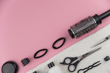 Professional hair dresser tools with copy space. Hair stylist equipment set on pink background....