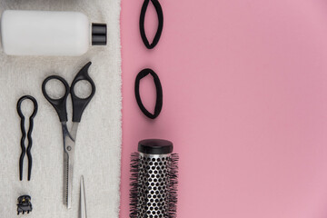 Professional hair dresser tools with copy space. Hair stylist equipment set on pink background....