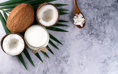 Beautiful composition with coconut oil and nuts on grey background