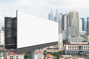 Blank white road billboard with KL cityscape background at day time. Street advertising poster, mock up, 3D rendering. Side view. The concept of marketing communication to promote or sell idea.