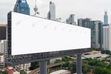 Blank white road billboard with KL cityscape background at day time. Street advertising poster, mock up, 3D rendering. Side view. The concept of marketing communication to promote or sell idea.