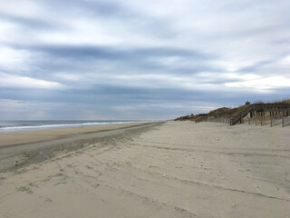 Beach expanse next to the ocean with sand dunes