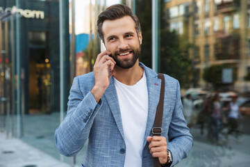 Young urban businessman on smart phone