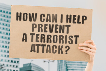 The question " How can I help prevent a terrorist attack? " on a banner in men's hand with blurred background. Advices. Recommendations. What to do. Security on the streets. Information. Preventive