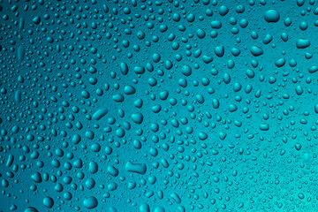 Close-up of water drops on glass . Abstract background texture.