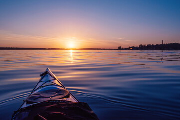 Sunset sky on the lake. View from the kayak