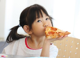 Little girl eating pizza 