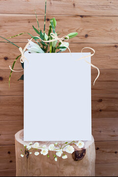 frame with flowers on wood wall background, mock up