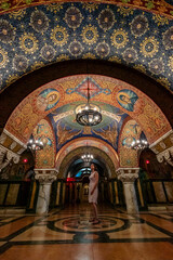 Woman looking at mosaic frescoes in Serbian orthodox church. Karadjordjevic dynasty church...