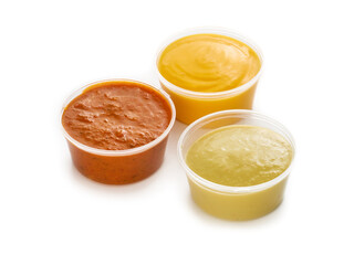 Plastic containers with sauces ketchup, mustard and cheese on white background, take away fast food delivery concept