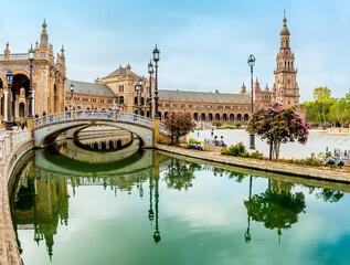 A view along a canal towards the southern side of the Plaza de Espana in Seville, Spain in the stillness of the early morning in summertime