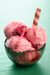 Raspberry ice cream close-up. Fruit ice cream in a bowl with toppings
