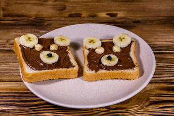 Two sandwiches with chocolate spread on a plate. Sandwich like a bear muzzle