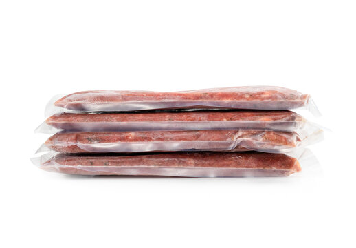 Multiple Frozen Meat Packages In A Pile, Vacuum Sealed. Front View. Ground Chicken Inclusive Backs, Necks, Liver And Heart. Concept For Raw Food Diet For Cats, Dogs And Pets. Isolated On White.