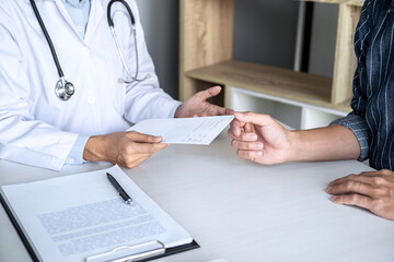 Doctor consulting patient discussing something symptom of disease
