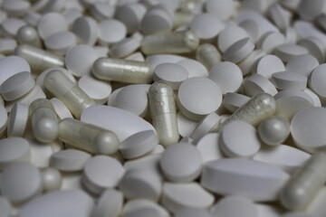 Full frame closeup of pile countless white pills and capsules