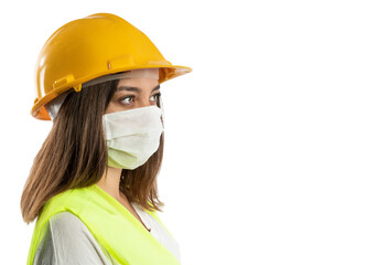 Amused young woman in yellow hardhat, green reflective vest and lumberjack shirt