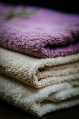 Towels over dark wooden background. Spa products