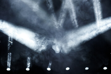 Ray of light with smoke and fog spotlights on the stage. Scene light equipment