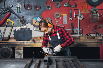 Worker girl with electric saw wheel grinding on steel structure in factory, light spark