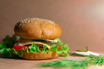 Fresh juicy cheeseburger. Big burger with beef, cheese and vegetables