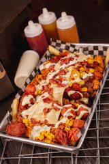 delicious crazy potatoes from colombia. french fries, chicken and cheese(papas locas)