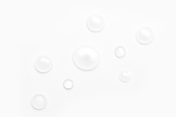 drops of water on a white background, top view