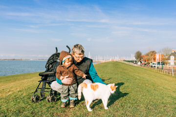 Man with toddler and cat on dyke