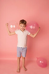 Happy baby boy on pink background with balloons. Celebration. birthday