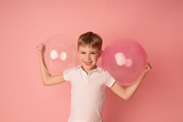 Happy baby boy on pink background with balloons. Celebration. birthday