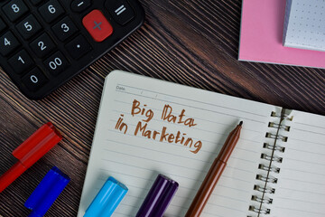 Bigdata in Marketing write on a book isolated wooden table.