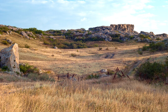 The rocks in the Azov steppe at the dawn under the blue sky in Ukraine