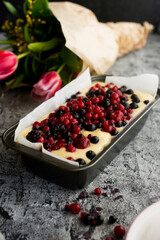  bread on a cutting board with berries ready to bake.