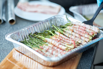 A bowl of food on a tray Asparagus in bacon - Powered by Adobe