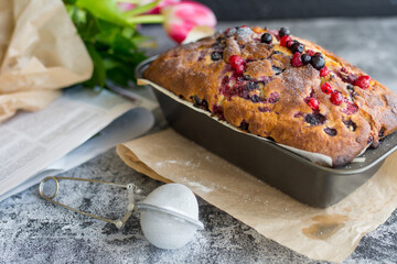 Loaf cake with red berries on the table