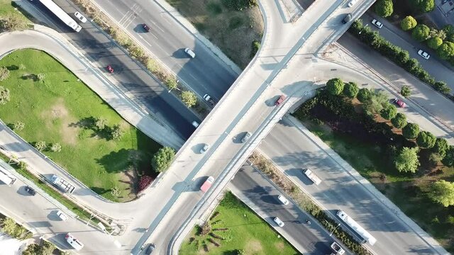 Aerial view of two lane bridge driveway. There is an inner ring road at the bottom. Vehicles and commercial vehicles can also be seen.