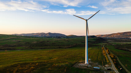 Detailed view of wind turbines on top of the mountains, blue cloudy sky at sunset, view from above, Ukrainian field in the Carpathians.
