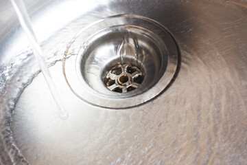 Water pours into the metal sink