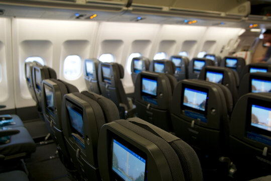 COPENHAGEN, DENMARK - NOV 24th, 2018: Empty Airplane Seats Waiting For Passengers And Take Off In An Airplane. Empty Plane Interior Before Flight And Departure. Watching Movie On An Aircraft