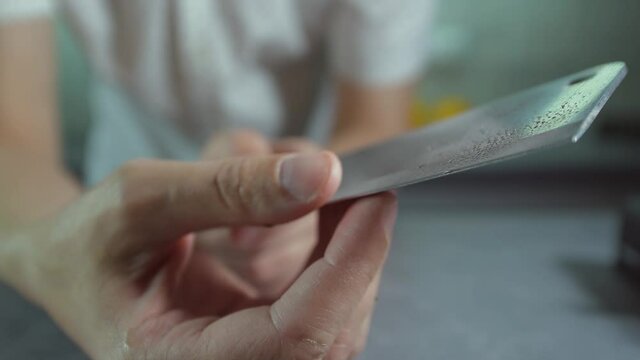 man sharpening knife.Sharpening kitchen knives, sharpening knives before cooking, sharpening knives on a cutting board
