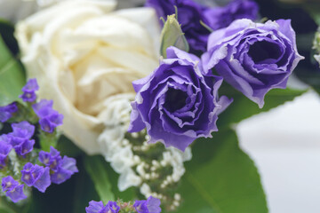 Beautiful bouquet of white and purple flowers. Decorative flower arrangement for the holiday. Closeup.