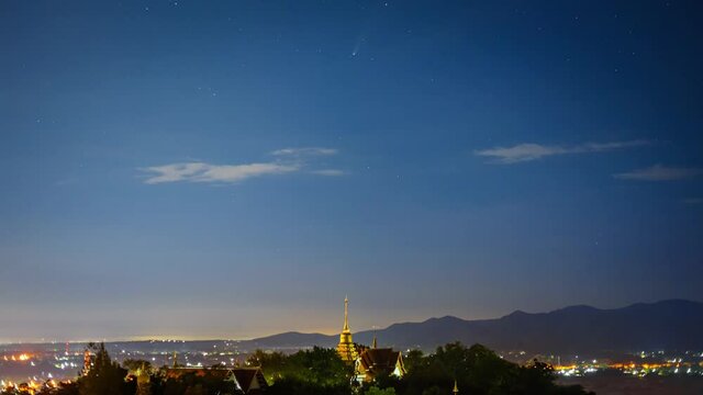time lapse of Neowise Comet ( C/2020 F3 )in cloudy  night sky over  WAT PRA THAT DOI SAKET temple