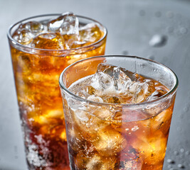 two cups of cold cola soft drink with ice