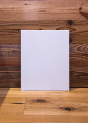 White frame on wooden wall background, mock up