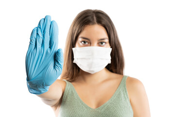 Young woman wearing medical face mask, studio portrait