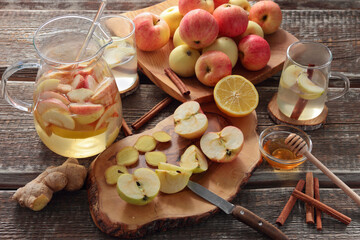 ingredients for refreshing drink, apples, ginger, lemon, honey, spices