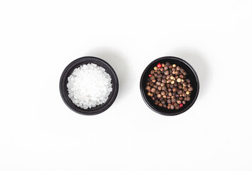 Salt and pepper in black bowl on white background - Powered by Adobe