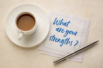 what are your strengths question - handwriting on a napkin with a cup of coffee, career and personal development concept